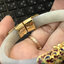 กำไลงาช้าง หุ้มด้วยทองแท้ และลงยา ทรงบานพับ และมีเซฟล็อค 9k GOLD NSYG1410