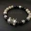 สร้อยข้อมือหินแท้ลาบราดอไลท์และนิลแท้ ตกแต่งด้วยชาร์มมังกรเงินแท้ Sterling Silver925 NSBL2255